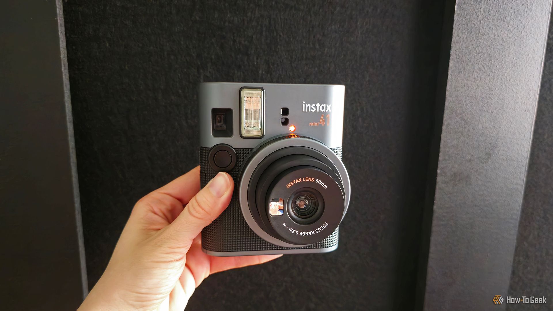 Someone holding the Fujifilm Instax Mini 41 instant camera.