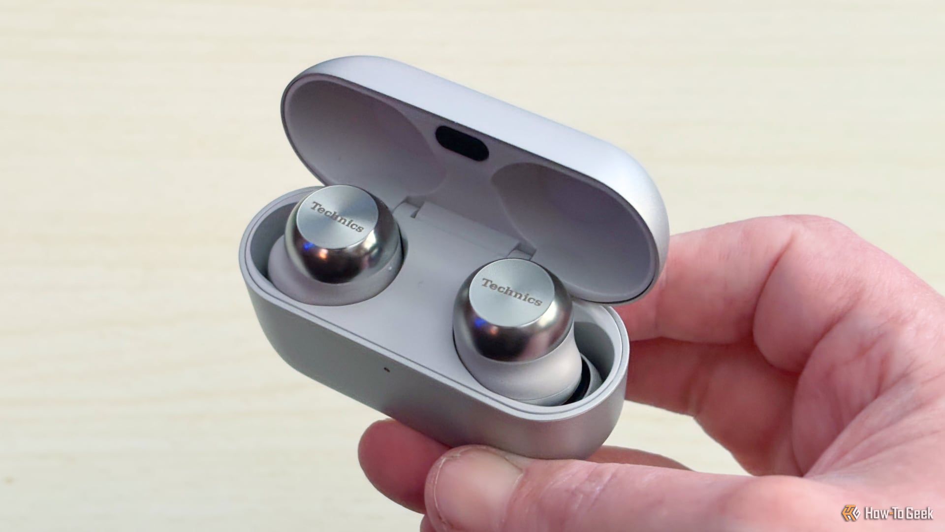 Technics AZ100 earbuds sitting inside the case.