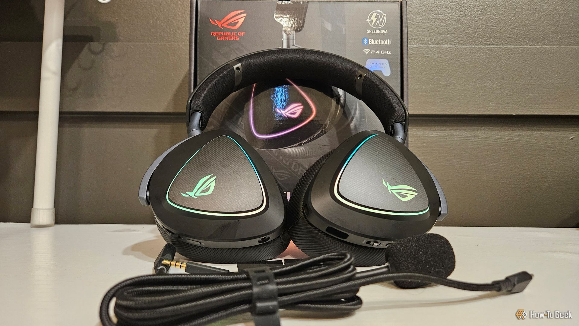 The ASUS ROG Delta II gaming headset leaning against its box on a table.