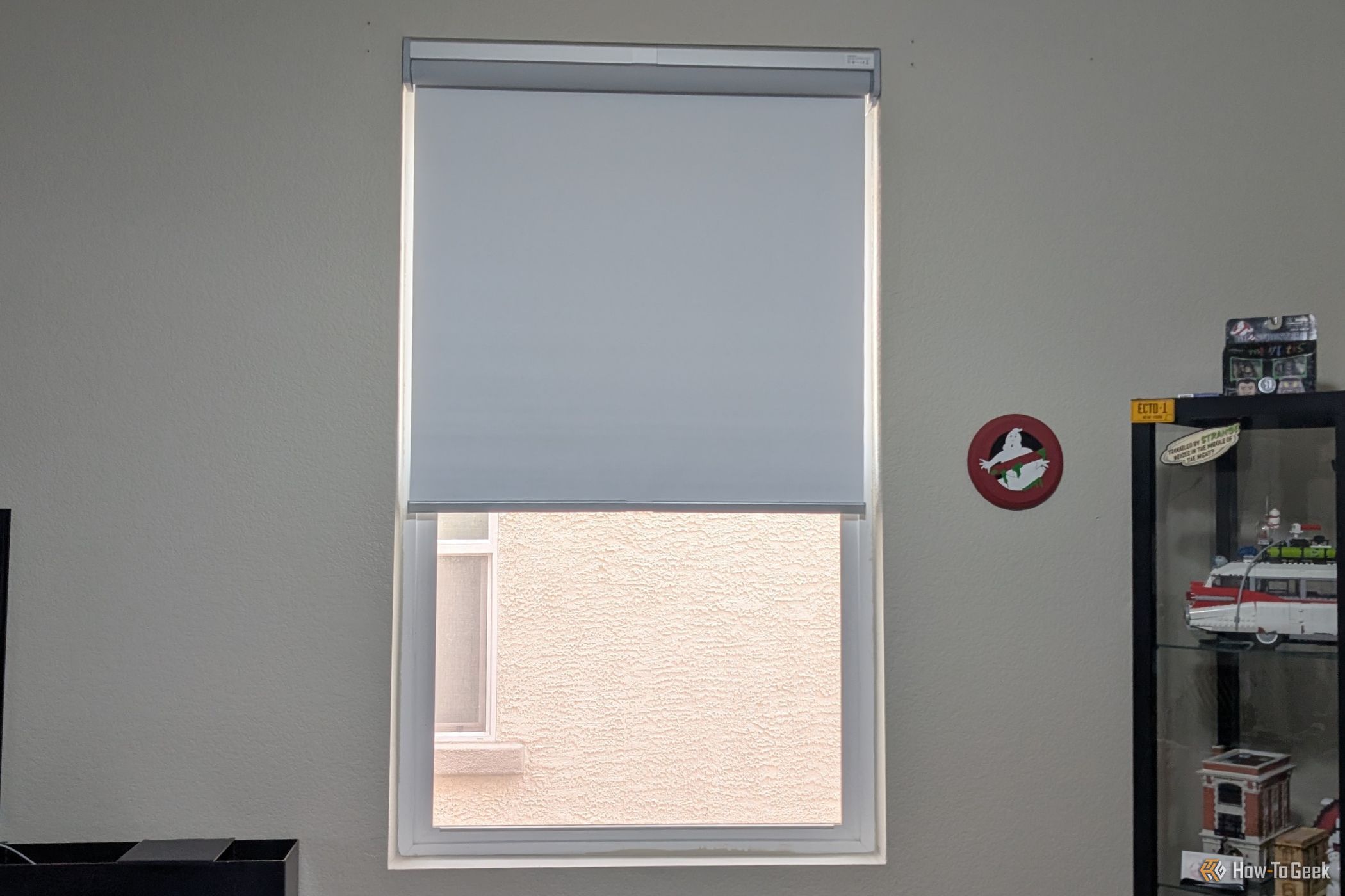 SwitchBot Roller Shade halfway closed looking outside.